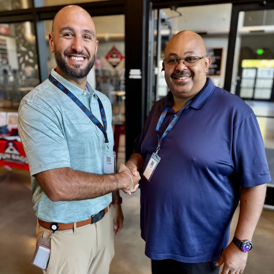 Two LeTip of Brick members shaking hands
