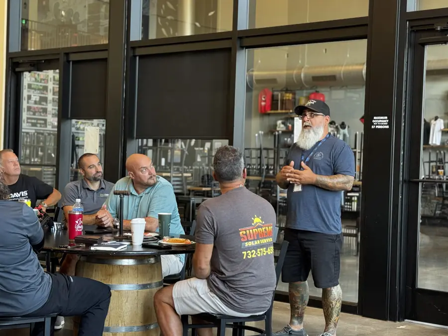 A member addresses the room at a weekly meeting