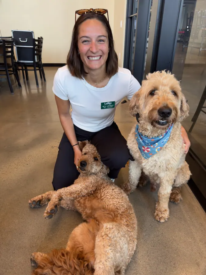 A member with her two dogs at a meeting