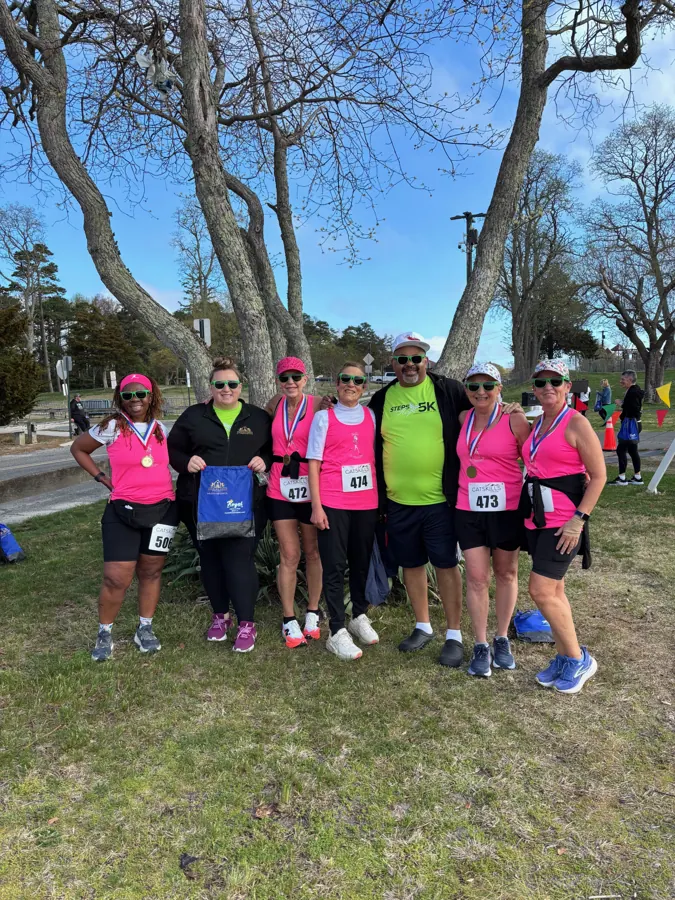 Runners in pink Steps For Hope shirts before the 5K